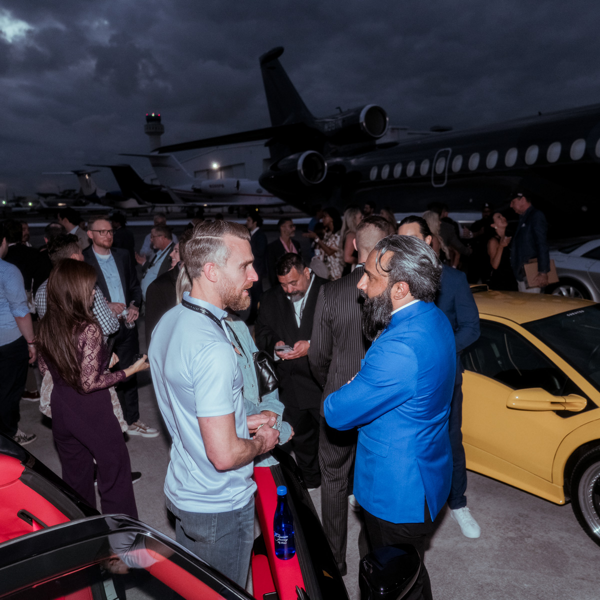 Guests gathered at a private aircraft event on the tarmac